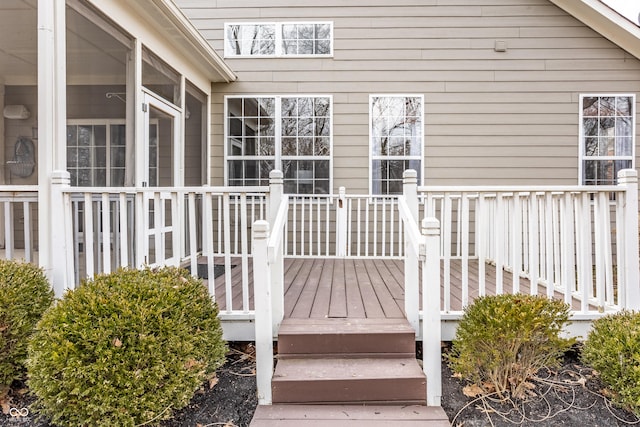 wooden deck with a sunroom