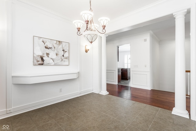 unfurnished dining area featuring a decorative wall, decorative columns, and ornamental molding