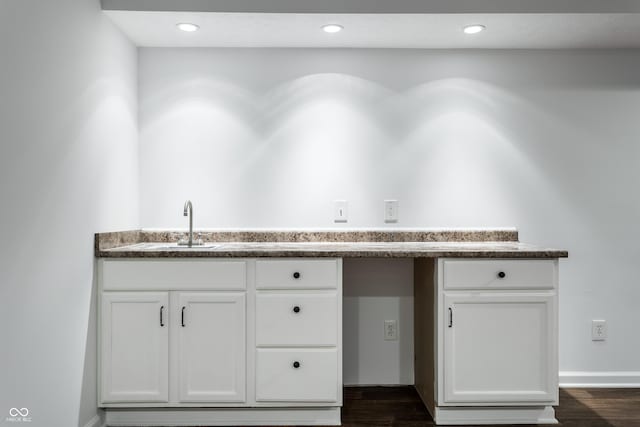 kitchen featuring white cabinetry, dark wood-type flooring, recessed lighting, and a sink