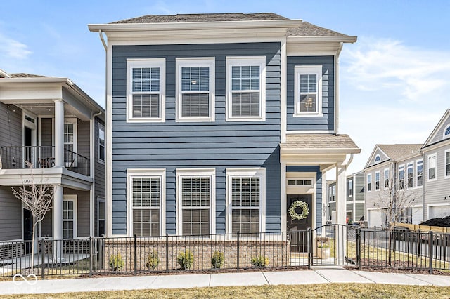 view of front of home with fence and a shingled roof