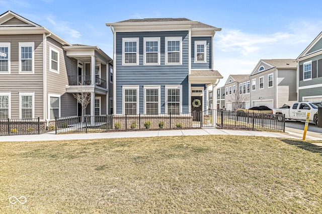 view of front facade with a front lawn, fence, and a residential view