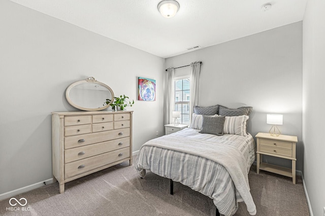 carpeted bedroom with baseboards and visible vents