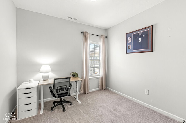 carpeted office with baseboards and visible vents