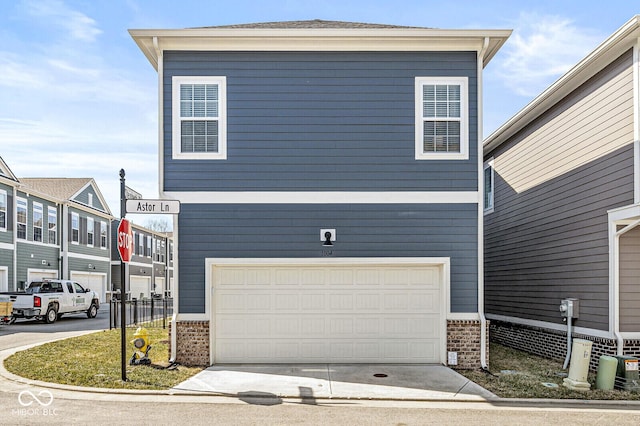 exterior space featuring concrete driveway, an attached garage, and brick siding