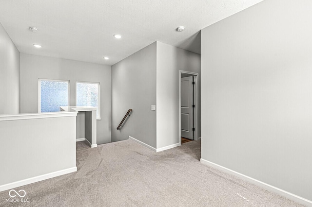 carpeted spare room with recessed lighting and baseboards