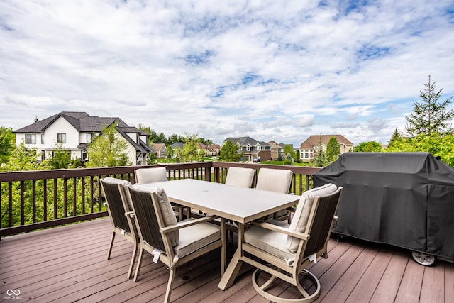 deck featuring grilling area, a residential view, and outdoor dining space