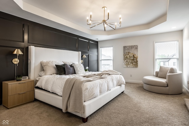 bedroom featuring an inviting chandelier, a raised ceiling, baseboards, and light carpet