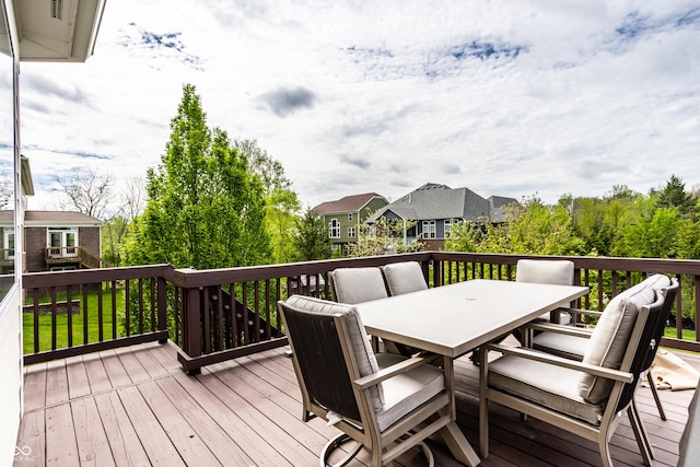 wooden terrace with a residential view and outdoor dining space