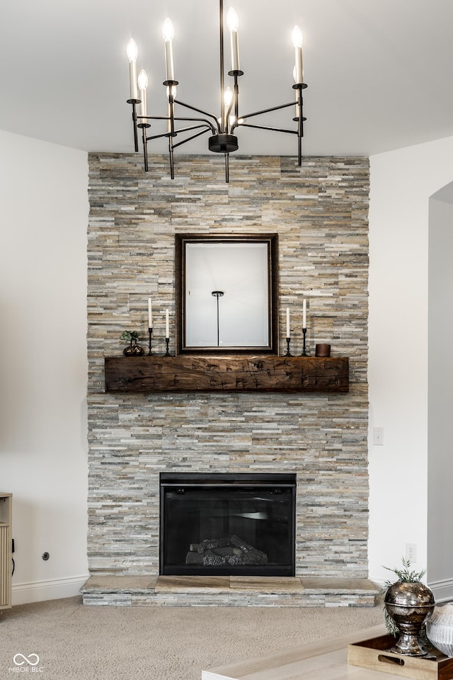 room details featuring baseboards, a fireplace, and a chandelier