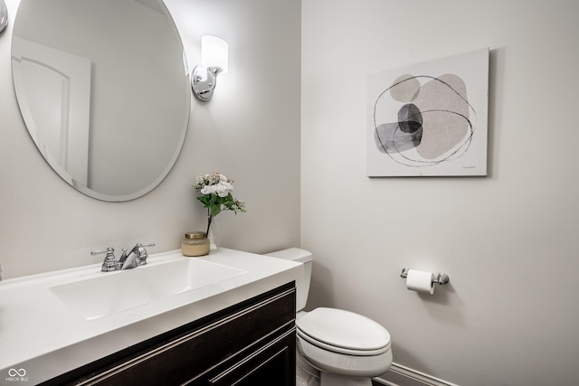 bathroom with toilet and vanity