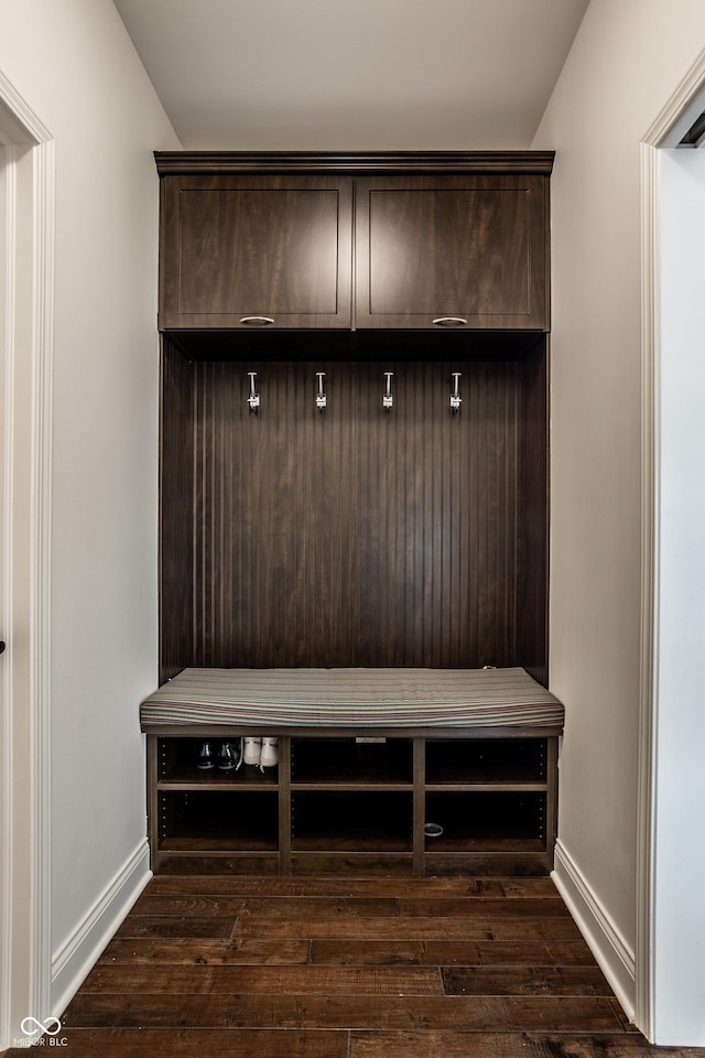 mudroom featuring baseboards and dark wood-style floors