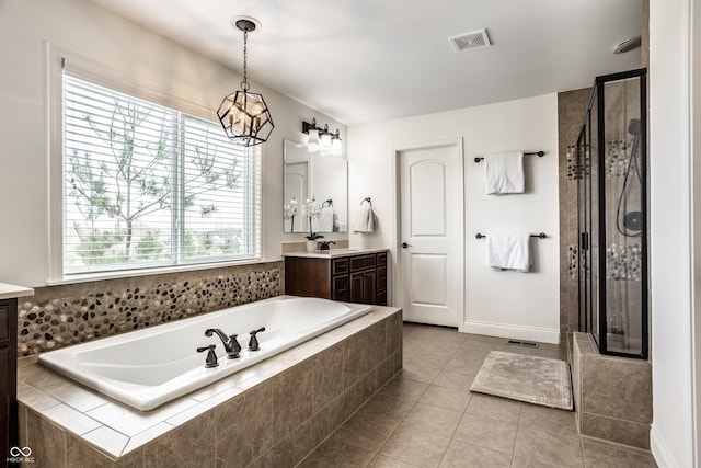 bathroom featuring vanity, a shower stall, a bath, and visible vents