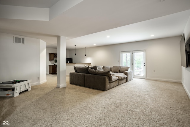 carpeted living room with baseboards, recessed lighting, and visible vents
