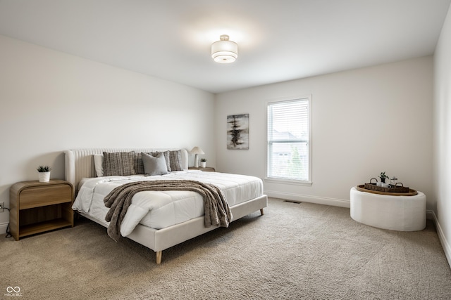 carpeted bedroom with baseboards and visible vents