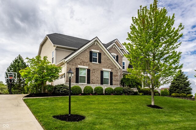 traditional home with a front lawn and brick siding