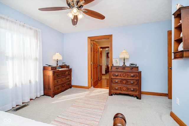 carpeted bedroom featuring visible vents, ceiling fan, and baseboards