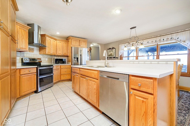 kitchen featuring wall chimney exhaust hood, stainless steel appliances, light countertops, and light tile patterned flooring