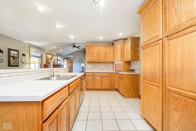 kitchen featuring lofted ceiling, light tile patterned flooring, a sink, light countertops, and decorative backsplash