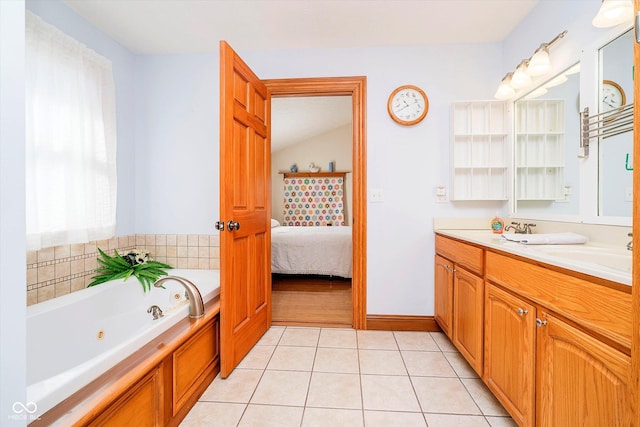 bathroom with a jetted tub, vanity, connected bathroom, and tile patterned floors