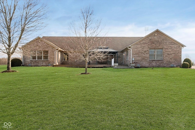 ranch-style house with brick siding, a front lawn, and a gazebo