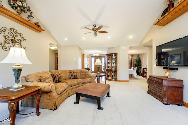 living area featuring arched walkways, recessed lighting, carpet flooring, baseboards, and vaulted ceiling