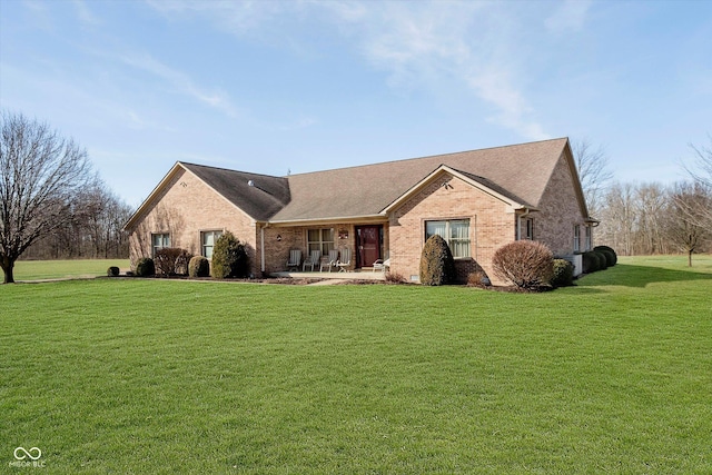 ranch-style home with brick siding and a front yard