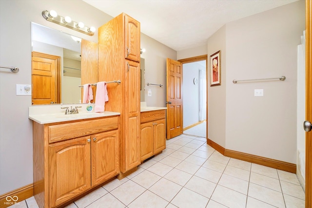 bathroom featuring tile patterned flooring, vanity, and baseboards