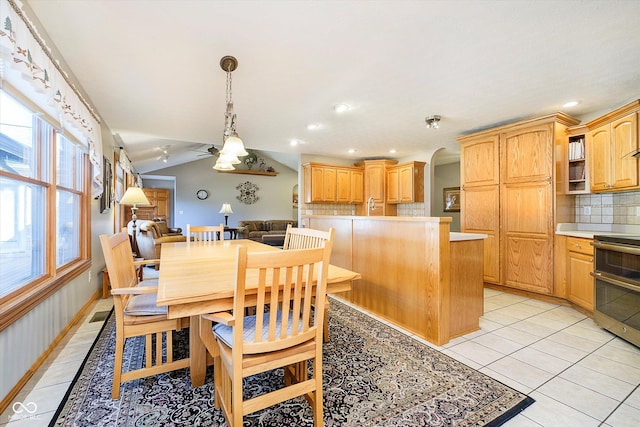 dining room with lofted ceiling, light tile patterned flooring, arched walkways, and recessed lighting