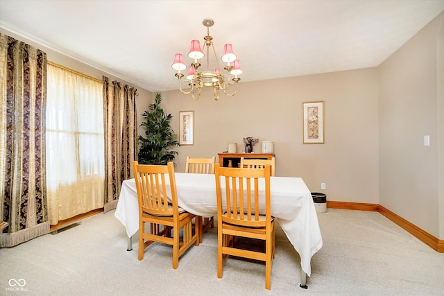 dining area featuring visible vents, light carpet, baseboards, and an inviting chandelier