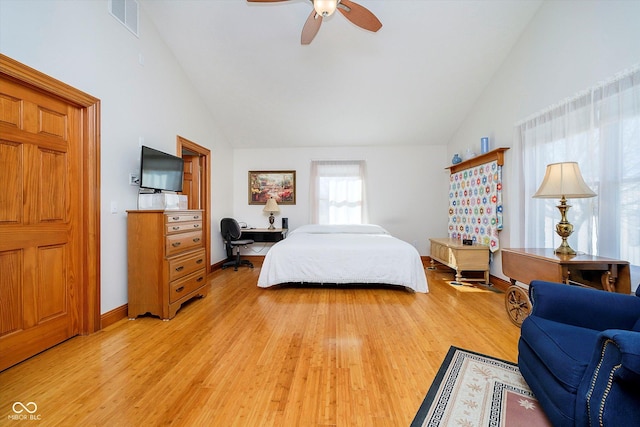 bedroom with ceiling fan, high vaulted ceiling, light wood-style flooring, visible vents, and baseboards