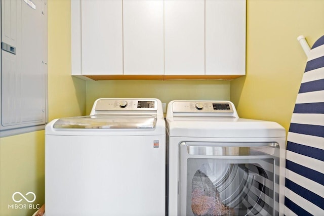 washroom with cabinet space and separate washer and dryer