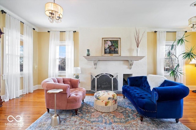 living room featuring a notable chandelier, wood finished floors, and baseboards