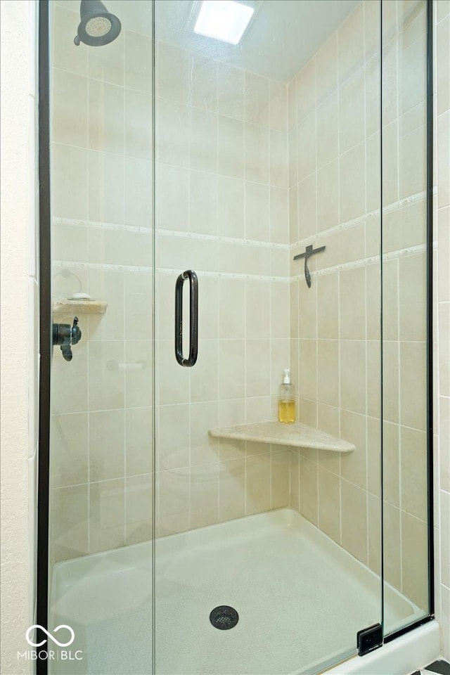 full bath featuring a shower stall