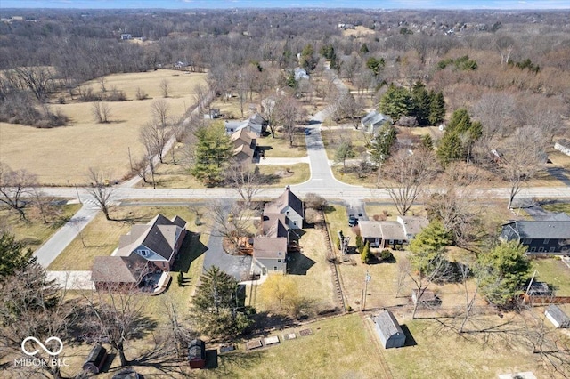 birds eye view of property with a view of trees