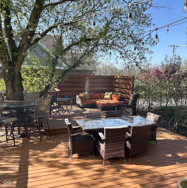 deck with outdoor dining space and an outdoor hangout area