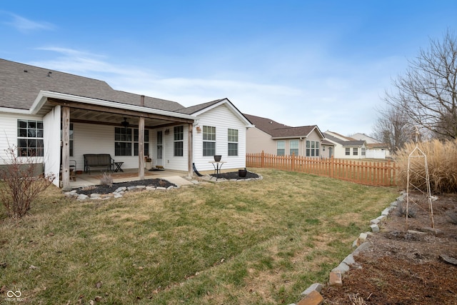 back of house featuring a yard, a shingled roof, a patio area, fence, and ceiling fan