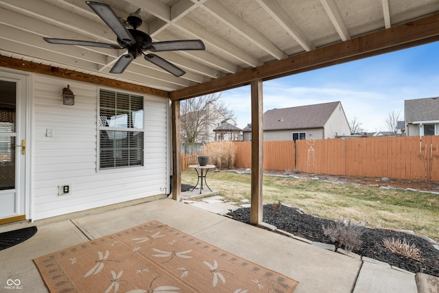 view of patio with ceiling fan and fence