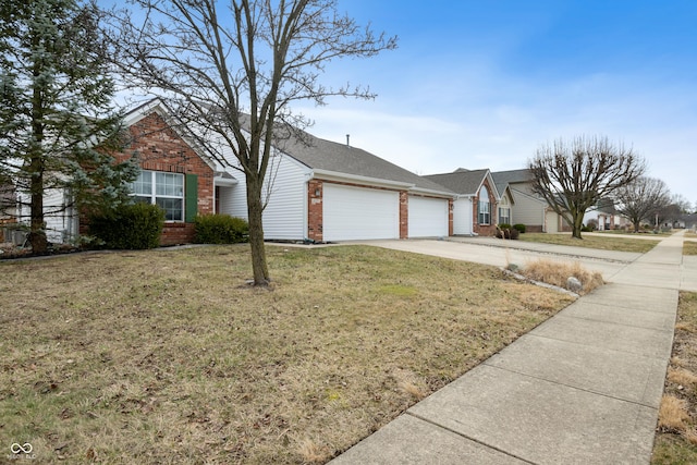 ranch-style home featuring driveway, brick siding, a front lawn, and an attached garage