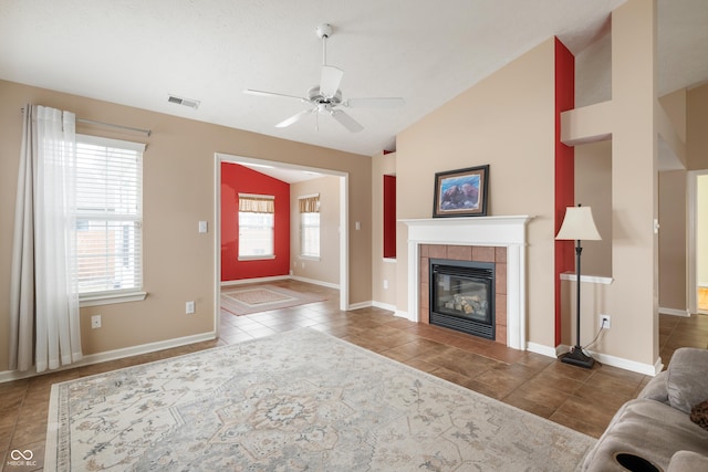 unfurnished living room with visible vents, baseboards, a tile fireplace, tile patterned flooring, and vaulted ceiling