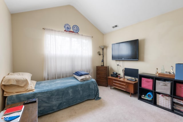 bedroom featuring lofted ceiling, carpet flooring, and visible vents