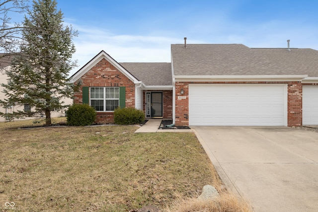 view of front of property with driveway, a front yard, and brick siding