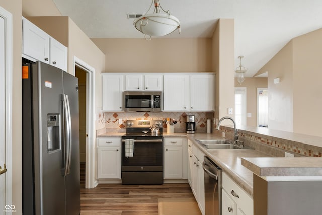 kitchen with white cabinetry, tasteful backsplash, appliances with stainless steel finishes, and a sink