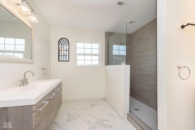 full bathroom featuring marble finish floor, visible vents, baseboards, and walk in shower