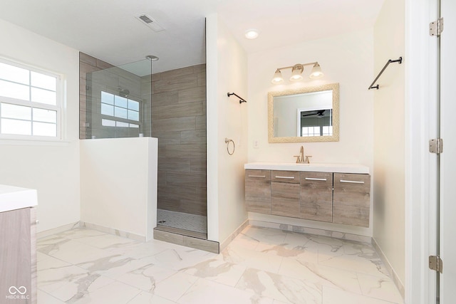 bathroom featuring marble finish floor, visible vents, walk in shower, and vanity