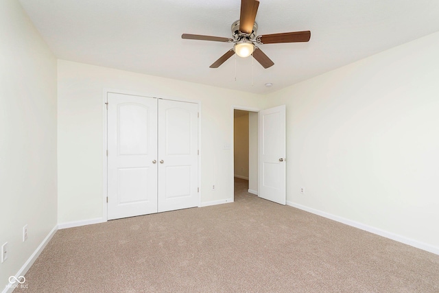 unfurnished bedroom with ceiling fan, a closet, carpet, and baseboards