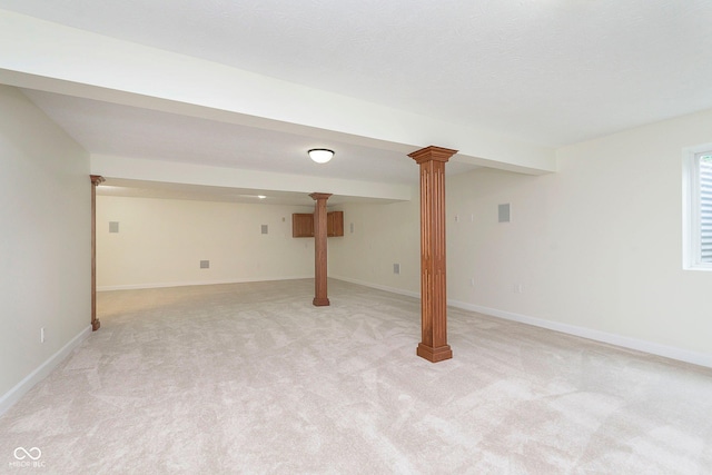 below grade area featuring baseboards and light colored carpet