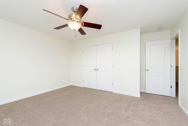 unfurnished bedroom with carpet floors, a closet, and baseboards