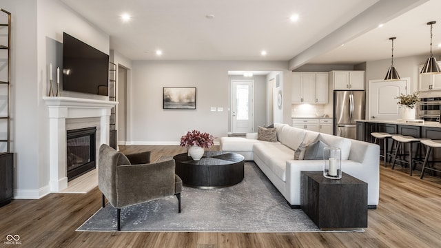 804 Whispering Oaks Dr, Carmel, IN 46032 - living area with wood finished floors, a fireplace, recessed lighting, and baseboards