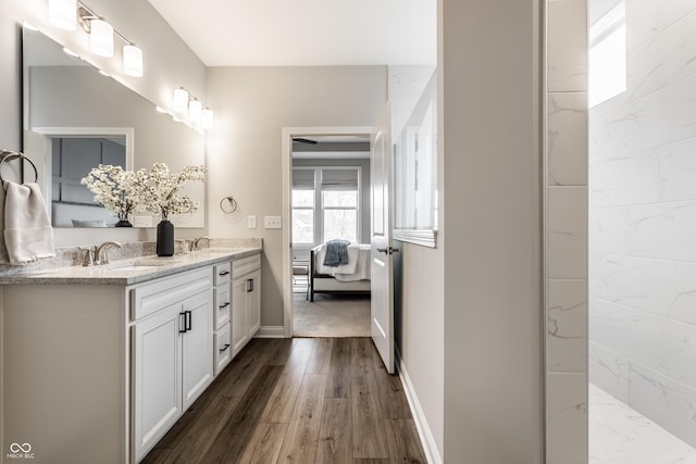 804 Whispering Oaks Dr, Carmel, IN 46032 - bathroom with double vanity, ensuite bathroom, wood finished floors, and baseboards