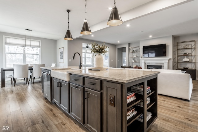 804 Whispering Oaks Dr, Carmel, IN 46032 - kitchen featuring a sink, dishwasher, a fireplace, light wood finished floors, and recessed lighting